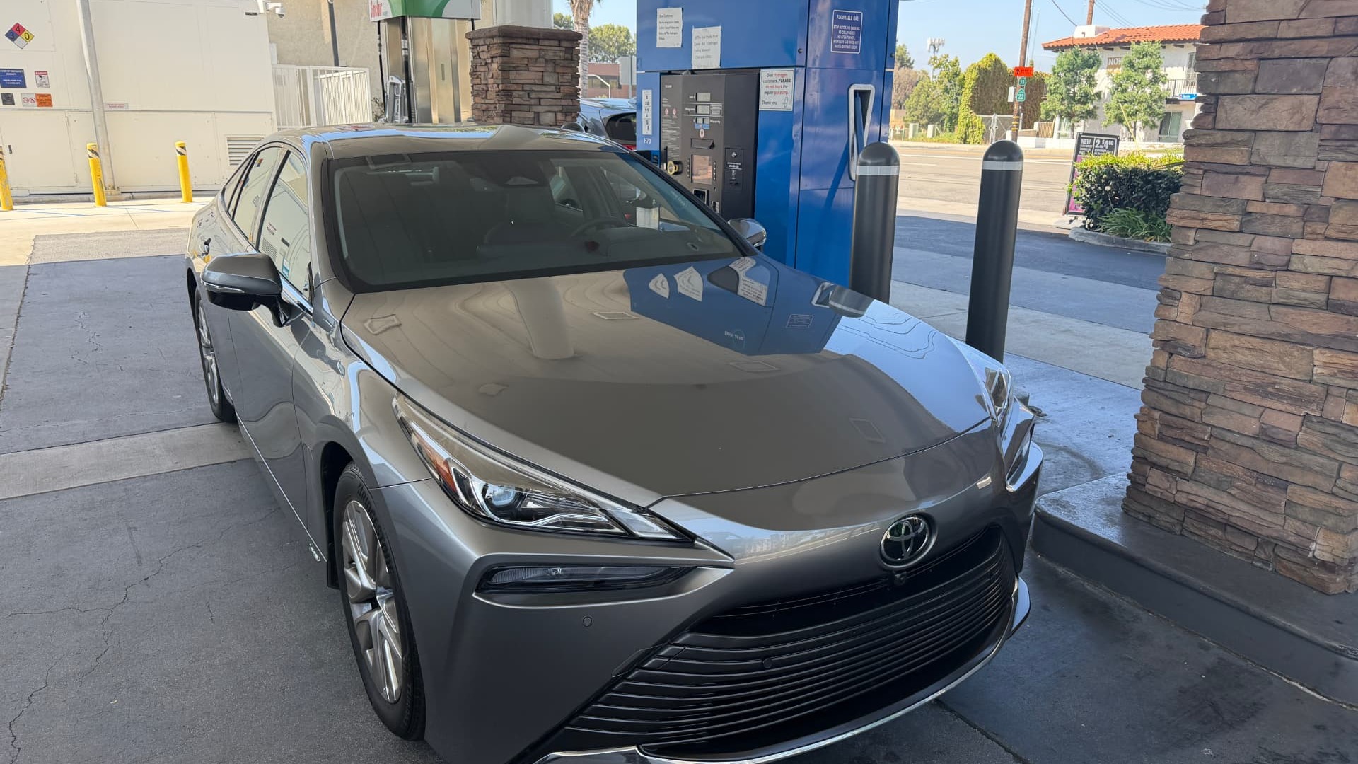 Silver Toyota Mirai parked at a blue True Zero hydrogen fueling station